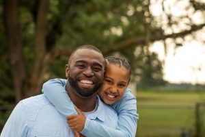 A father and daughter laughing together.